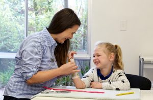 A hand specialist examining a young girl's wrist.