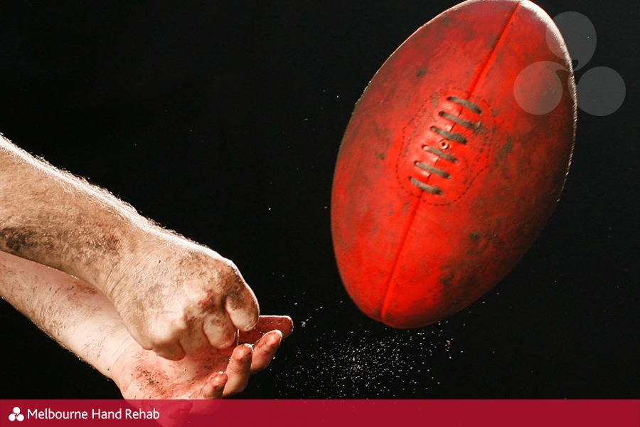 Hand balling an Australian Rules football (AFL)