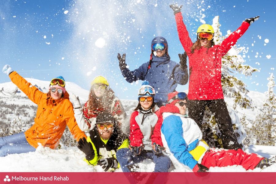 Group of excited skiers in the snow. Read our blog: Ski season is here and so is skiers thumb.