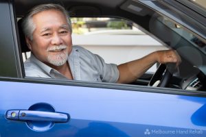 Man sitting at the wheel of a blue car. 'Can I drive with a splint or brace on'?