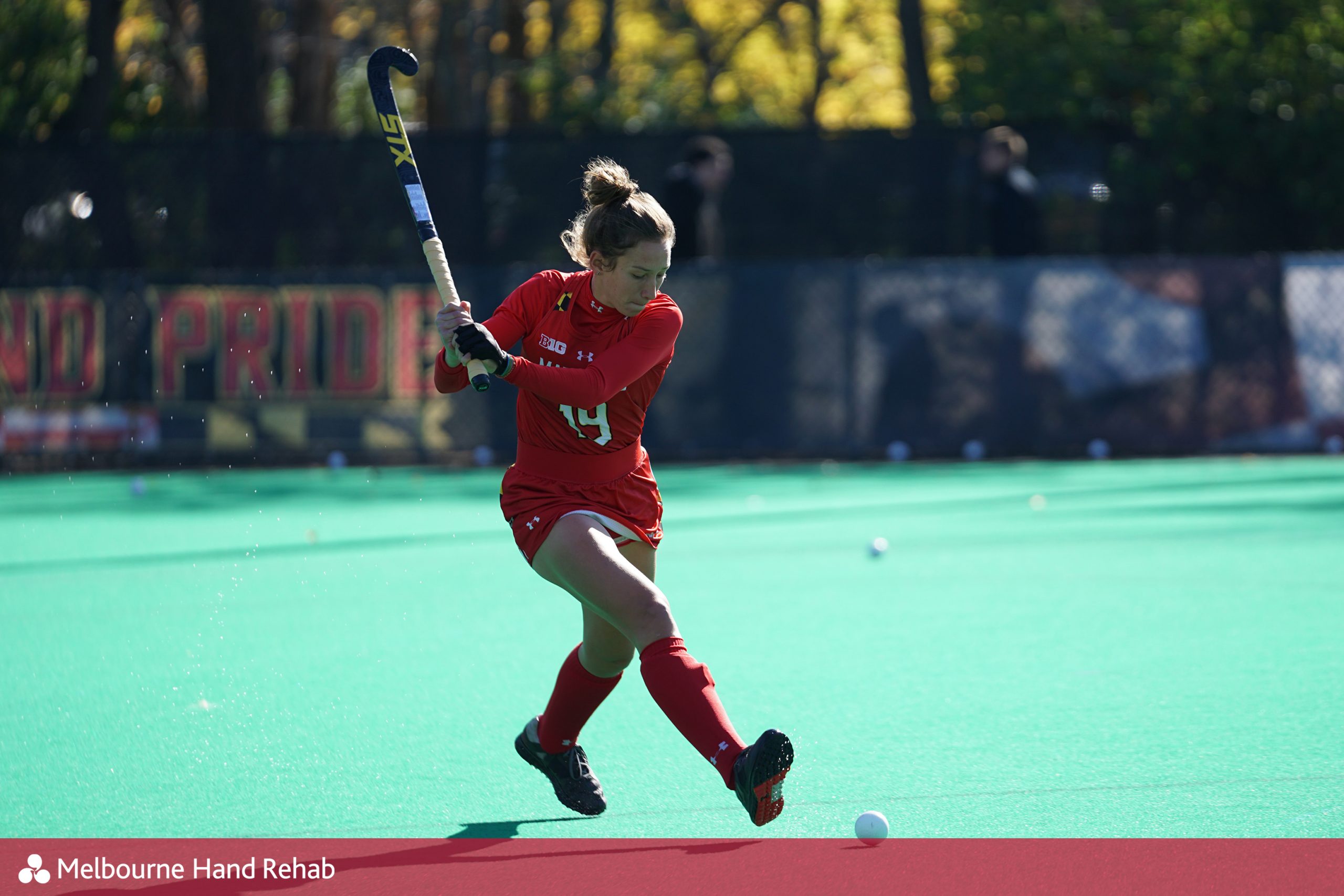 Female hockey player with raised stick