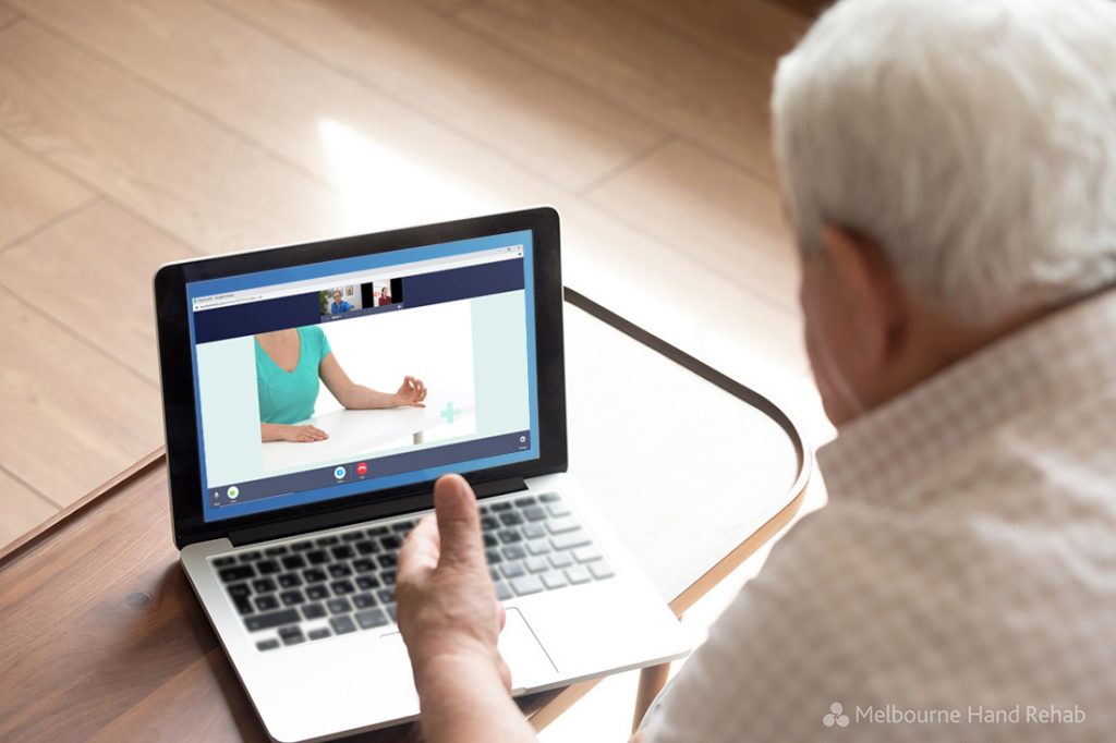 Older man using Melbourne Hand Rehab telehealth hand therapy online video consultation service