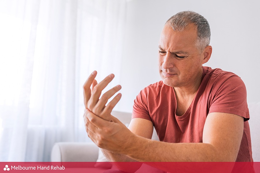 Man with painful hand before visiting a hand therapist