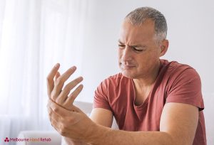 Mature man suffering from wrist pain