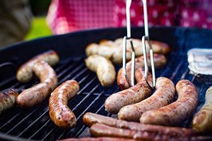 Sausages in BBQ during backyard cricket match