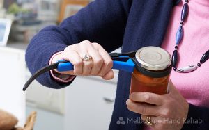 Senior Woman Taking Lid Off Jar With an arthritis Kitchen Aid