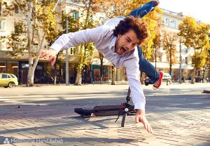 Man falling off an electric scooter