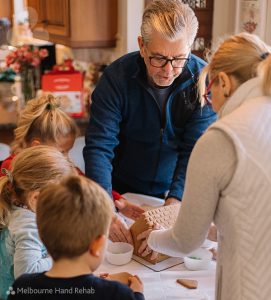 Family making gingerbread house. Handy tricks & tools for Xmas baking if you have arthritis.