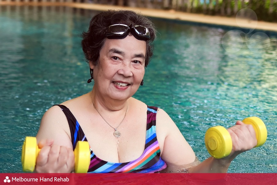 Older women participating in a hand therapy hydrotherapy class