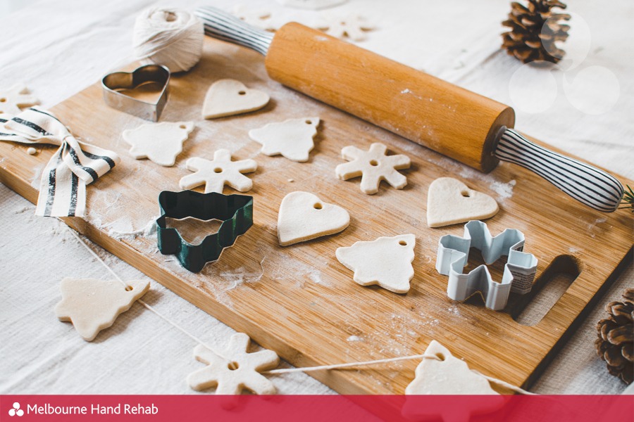 White, salt dough, homemade Christmas tree ornaments in the shape of trees, hearts and snowflakes.
